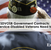 A back view of a veteran saluting in front of a U.S. flag, SDVOSB Government Contracts